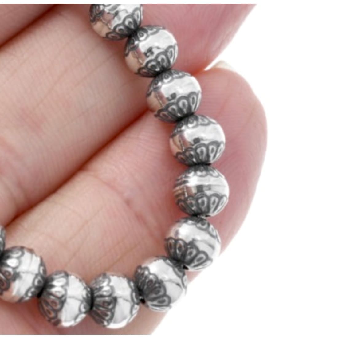 Close-up of Native American Navajo pearls necklace sterling silver with detailed engraved beads