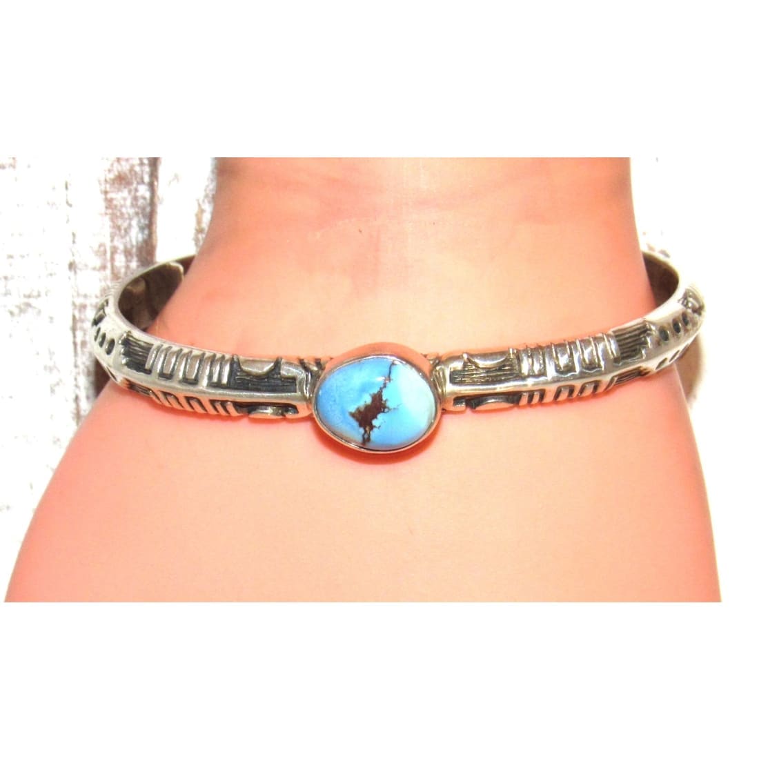 Navajo Golden Hills turquoise sterling bracelet with ornate silver band and blue stone centerpiece