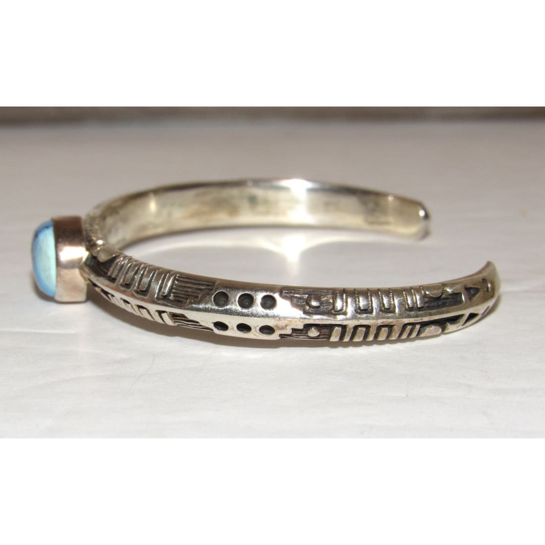 Navajo Golden Hills turquoise sterling bracelet with tribal engravings on silver cuff