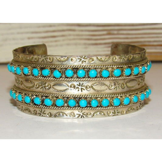 Native American Zuni turquoise snake eye cuff bracelet with intricate silver detailing and vibrant turquoise stones