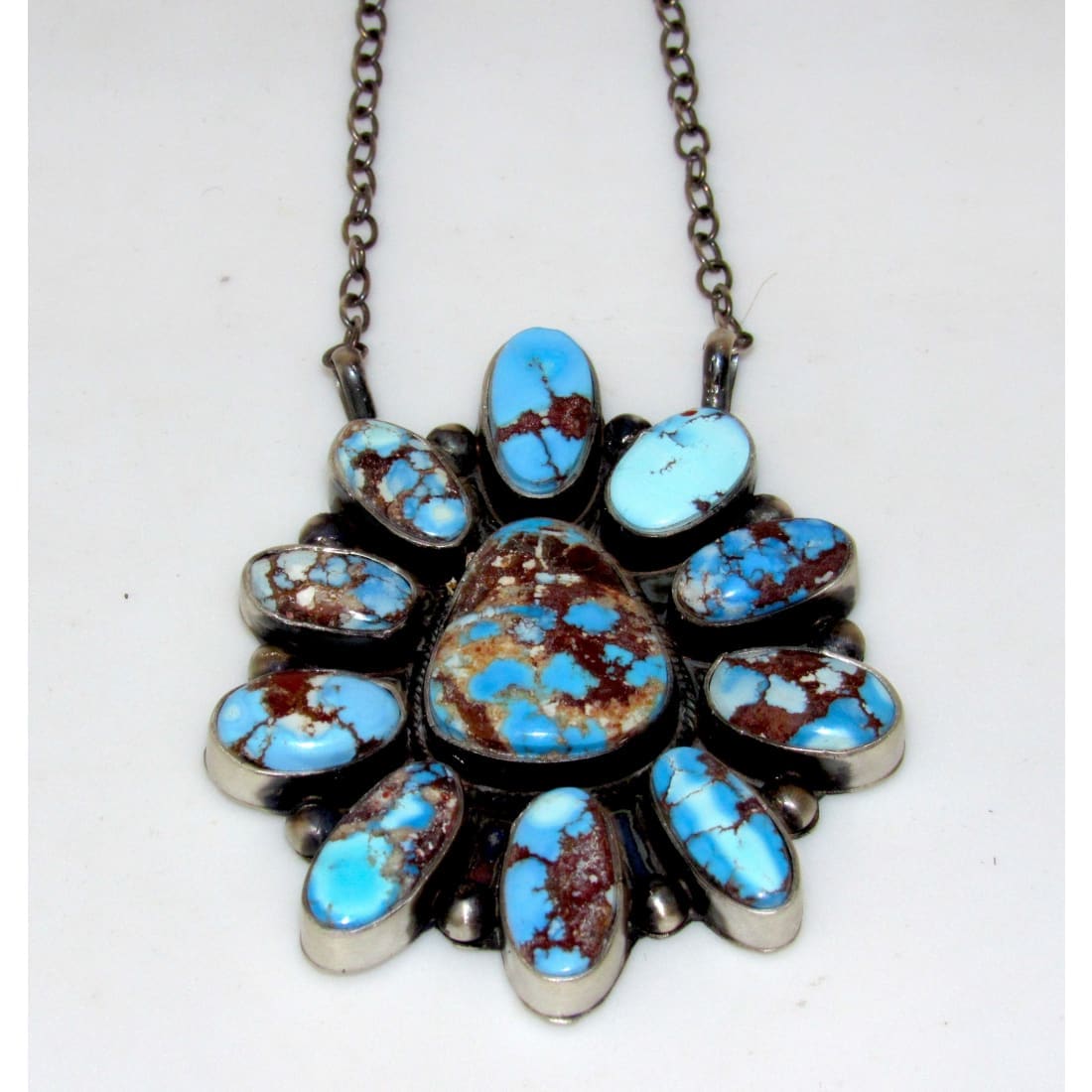 Navajo Golden Hills turquoise bar necklace with multiple blue and brown turquoise stones in silver setting