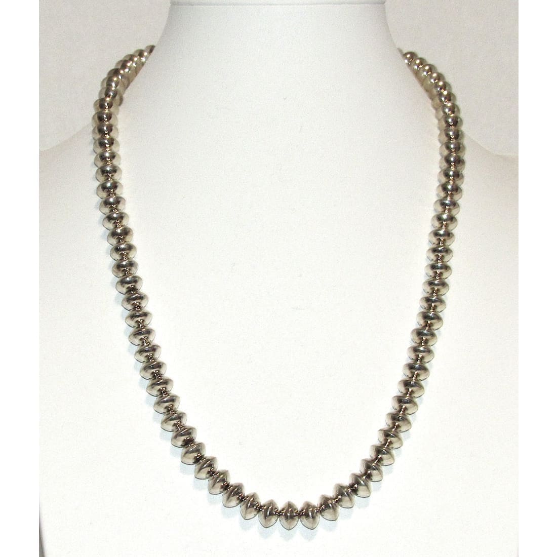 Vintage Navajo pearls necklace with silver beads displayed on white mannequin bust
