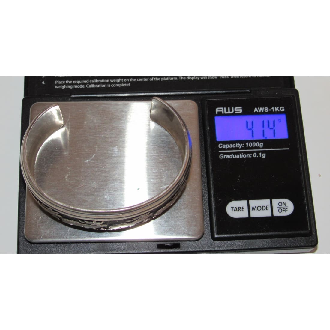 Tommy Singer sterling silver bracelet displayed on a digital scale showing 41.4 grams weight