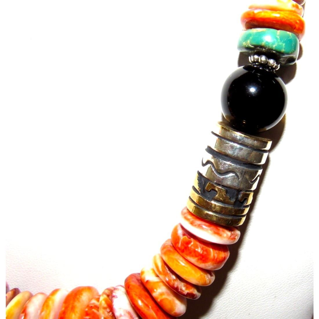 Navajo Tommy Singer orange spiny oyster necklace featuring vibrant shells and elegant sterling silver accents.