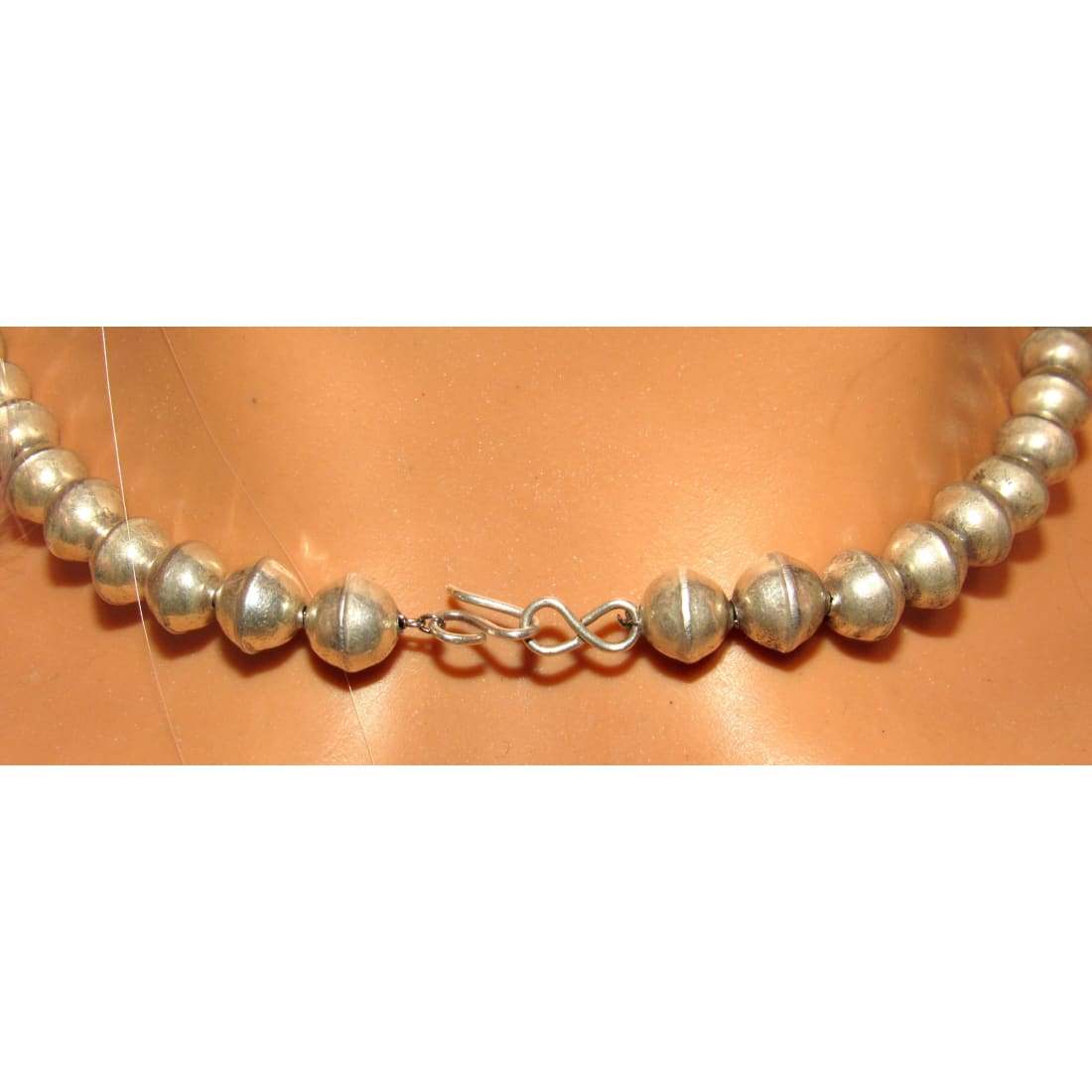 Navajo pearls necklace with graduated beads, hand stamped sterling silver design, featuring a hook closure.