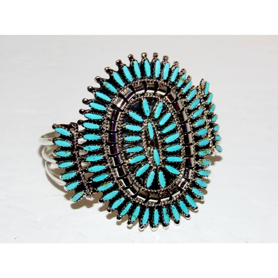 Navajo turquoise cluster cuff bracelet featuring vibrant Sleeping Beauty turquoise stones and intricate silver detailing.