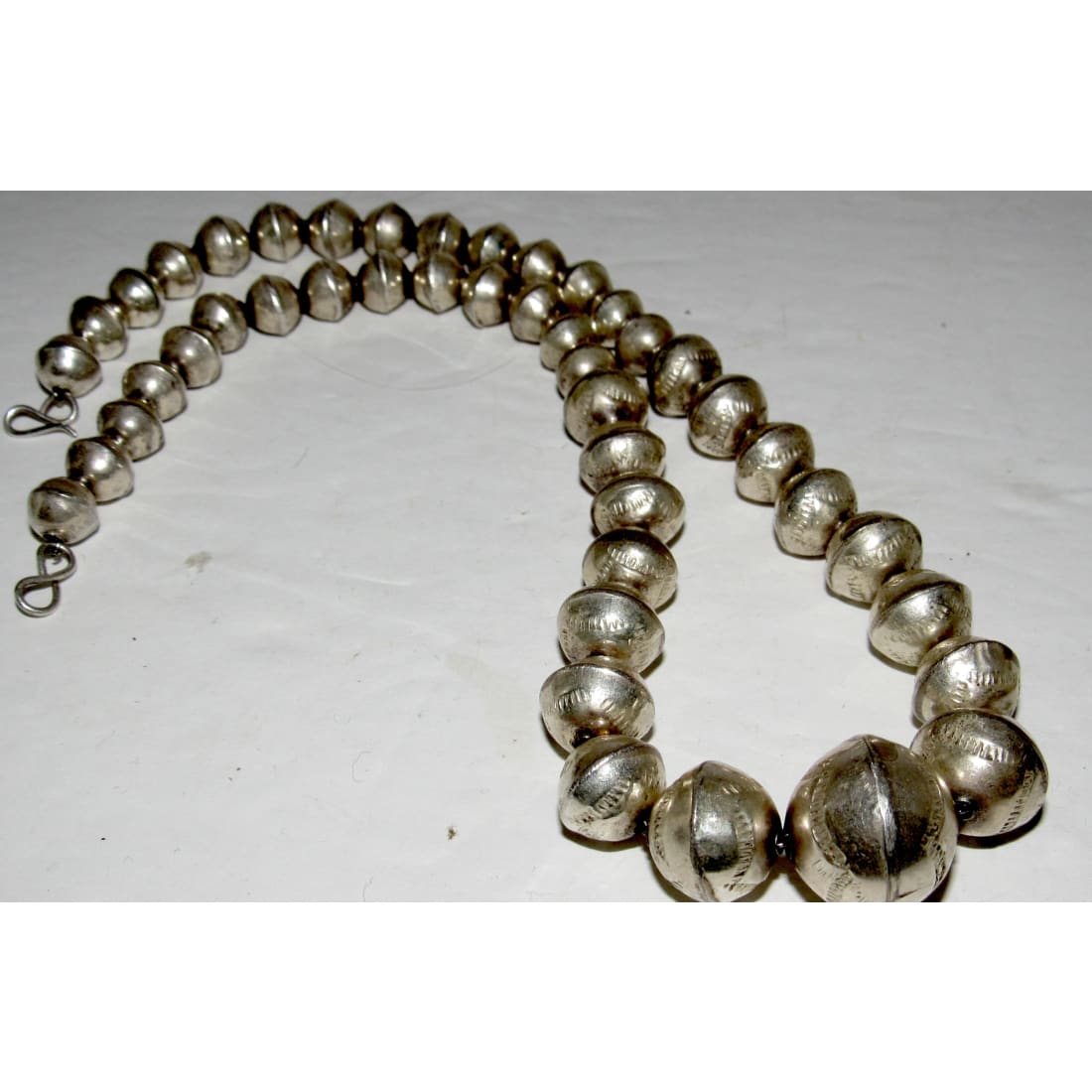 Navajo pearls necklace with graduated hand stamped sterling silver beads on a foxtail chain measuring 18 inches.