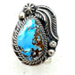 Navajo Golden Hills turquoise ring on a silver setting with intricate designs and a striking blue turquoise stone.