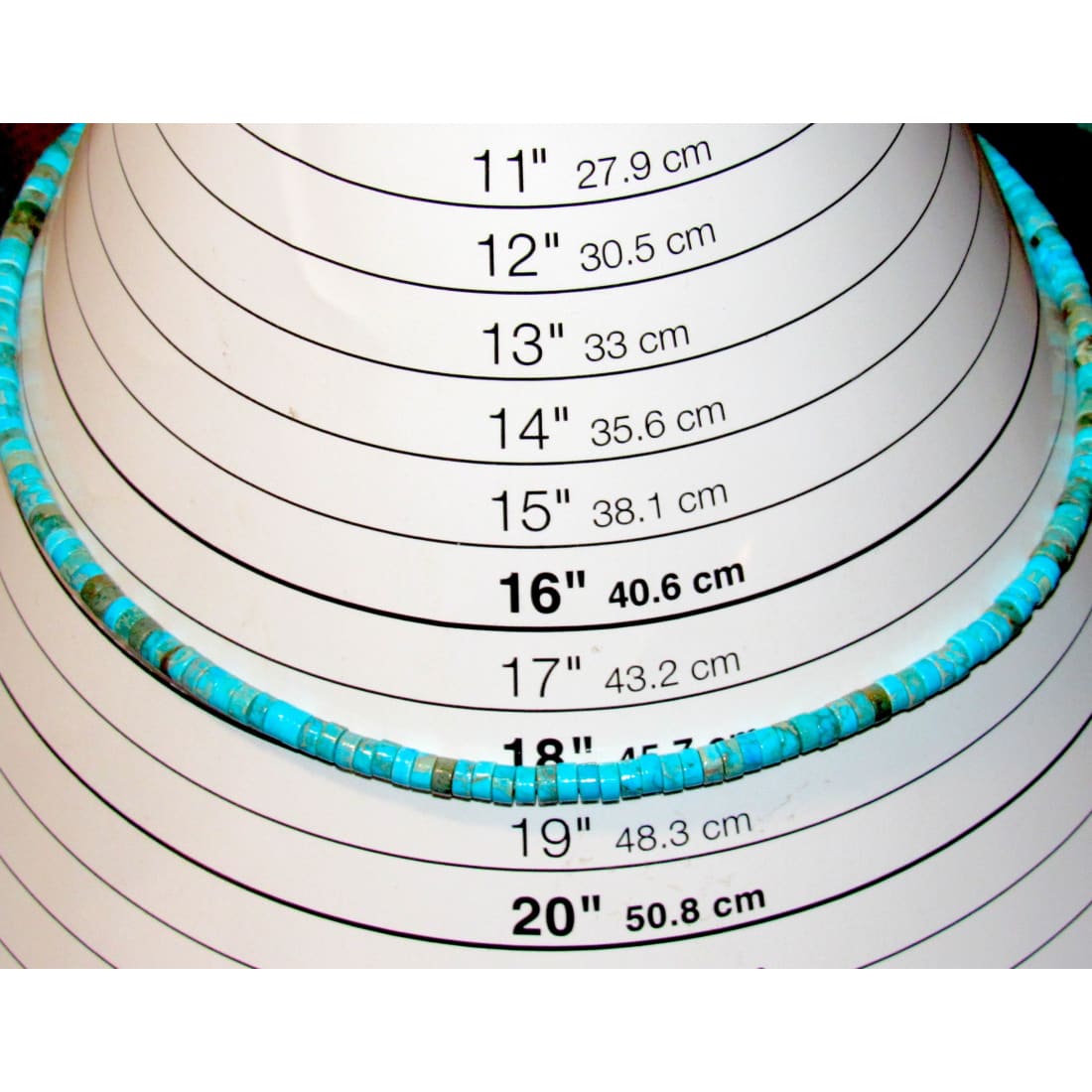 Navajo turquoise heishi choker necklace displayed on a measuring bust, showcasing 16" length and beautiful turquoise beads.