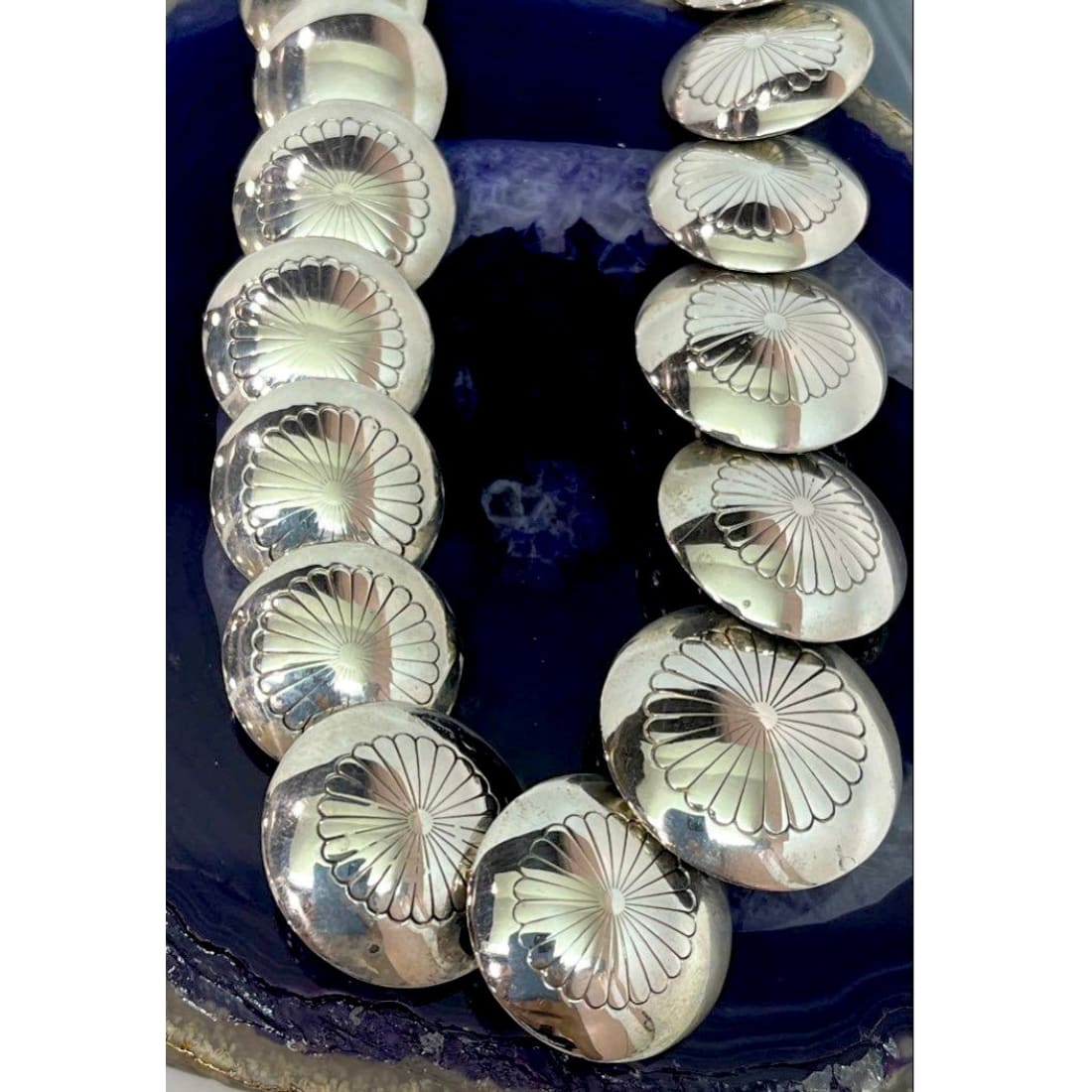 Vintage Navajo pearls necklace earrings set with handcrafted ingot design and pillow beads on a blue agate background.
