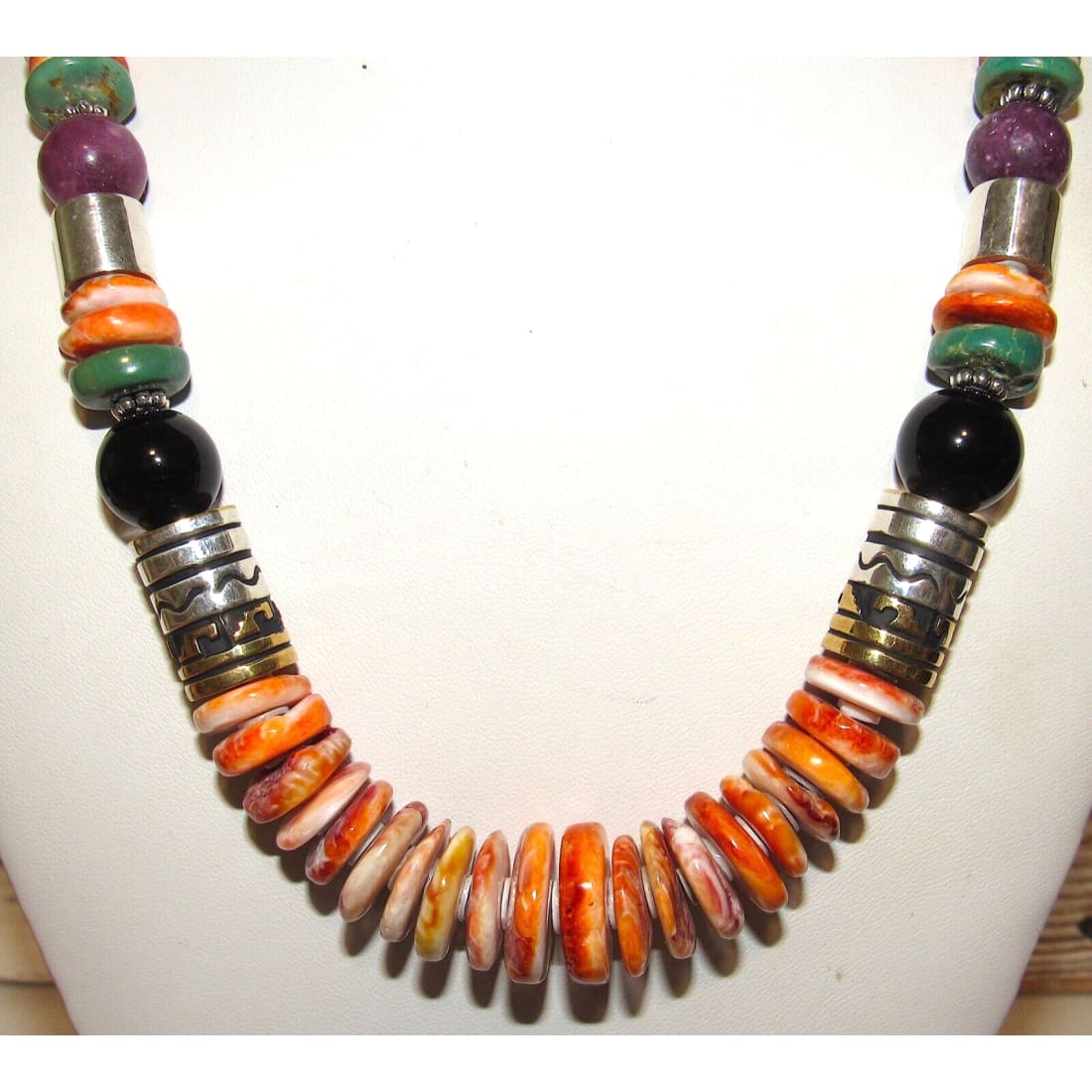 Navajo Tommy Singer orange spiny oyster necklace with vibrant shells and sterling silver accents, 20 inches long.