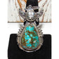 Native American Navajo turquoise kachina ring with detailed silverwork and vibrant blue green stone