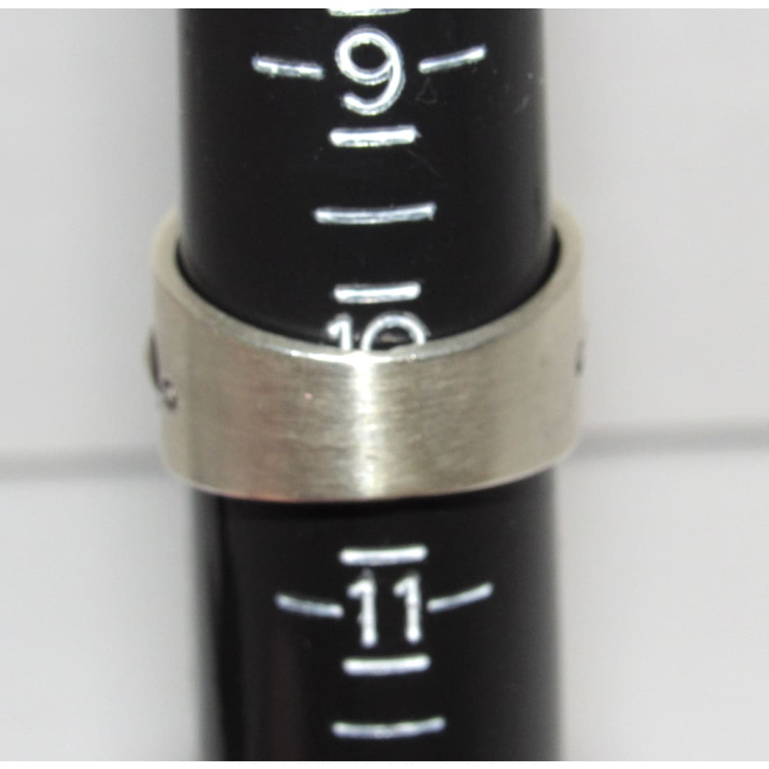 Navajo sterling silver ring size 10 band on measuring stick showing size with ethnic design