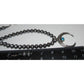 Vintage Navajo squash blossom necklace set with silver beads and turquoise crescent pendant on ruler background