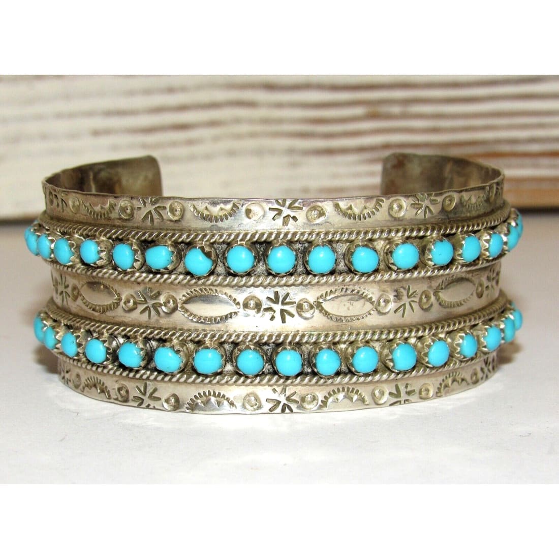 Native American Zuni turquoise snake eye cuff bracelet with intricate silver detailing and turquoise stones