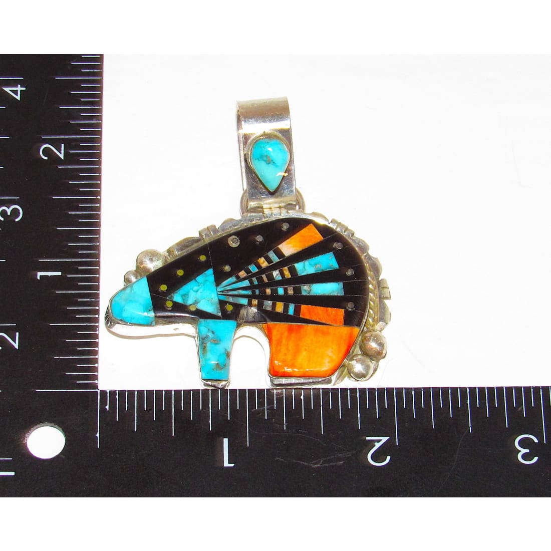 Native American Navajo bear pendant turquoise spiny oyster inlay with silver setting shown with ruler