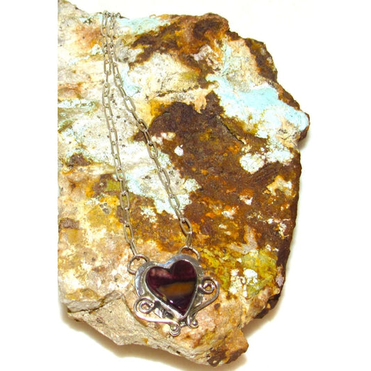 Purple spiny oyster heart pendant Navajo necklace with sterling silver chain on rustic rock