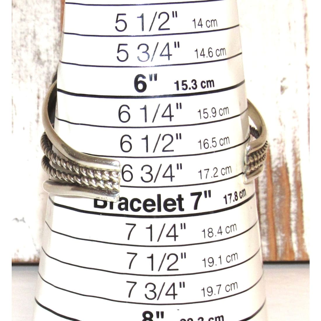 Navajo turquoise coral sterling silver bracelet Joelias Draper displayed on a size measuring cone