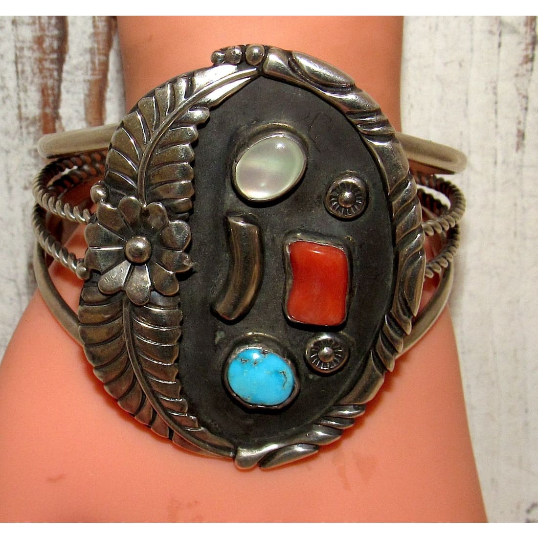 Native American Navajo turquoise coral sterling silver bracelet Joelias Draper with intricate floral and feather designs