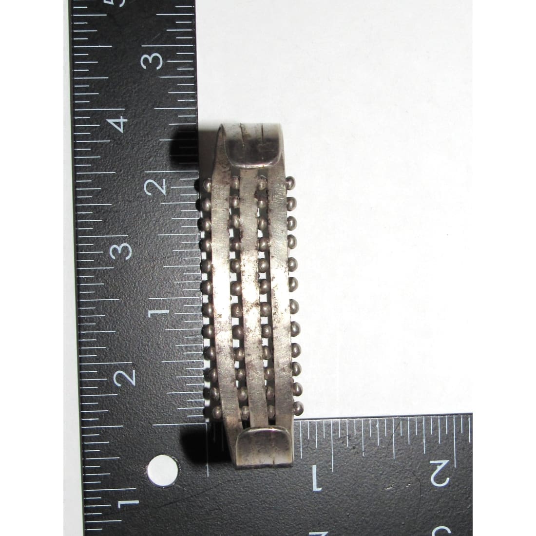 Zuni snake eye bracelet silverwork shown with ruler for size