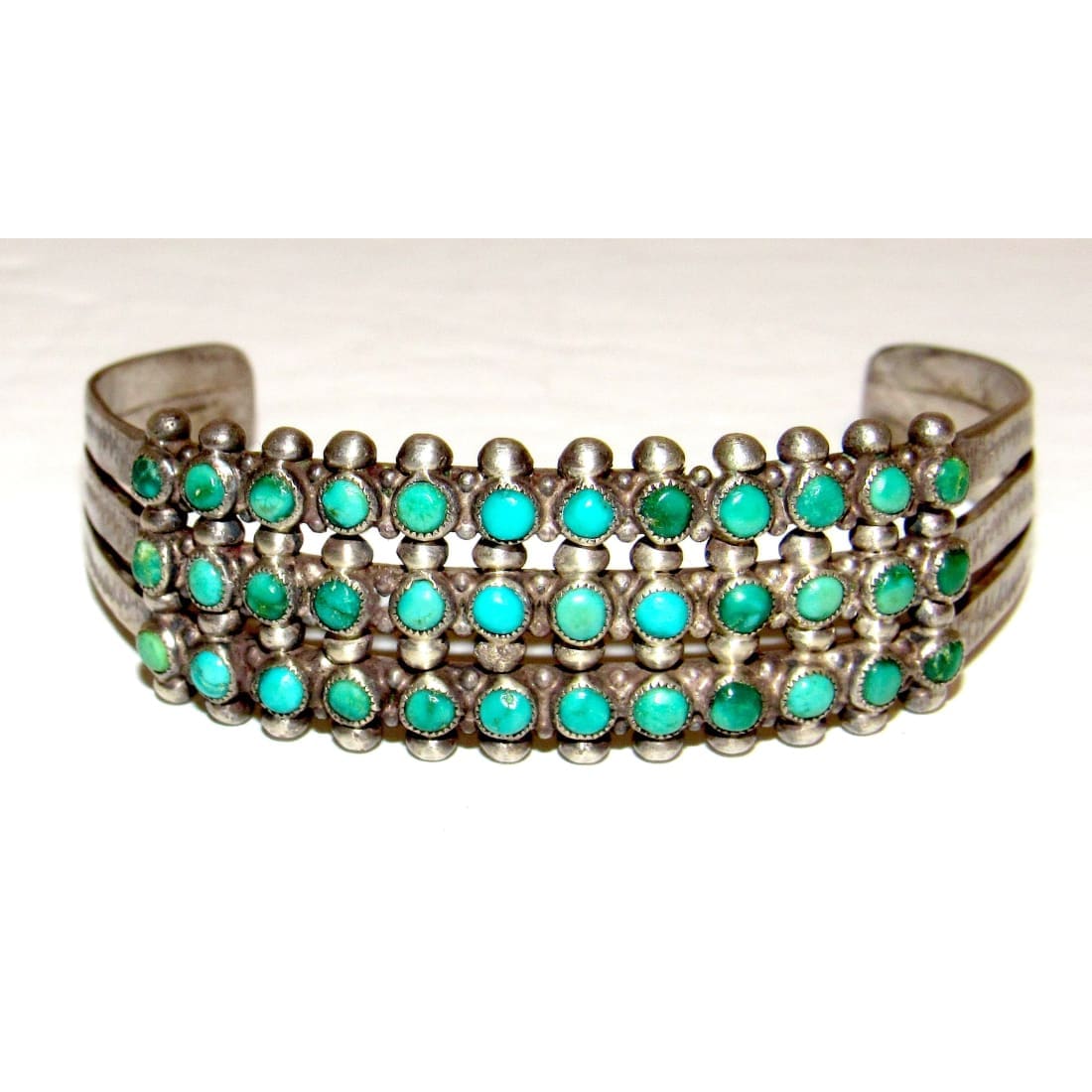 The Southwestern Style  Zuni snake eye turquoise cuff bracelet with three rows of vibrant turquoise stones