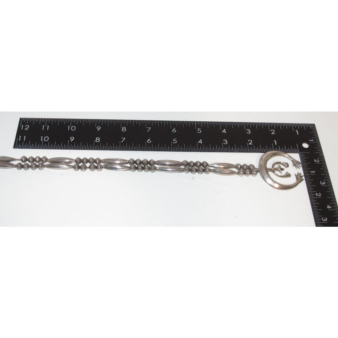 Vintage Navajo squash blossom necklace in silver with detailed beadwork and traditional design