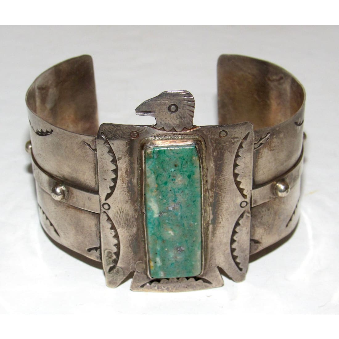 Native American Navajo Thunderbird cuff bracelet with turquoise stone and detailed silverwork