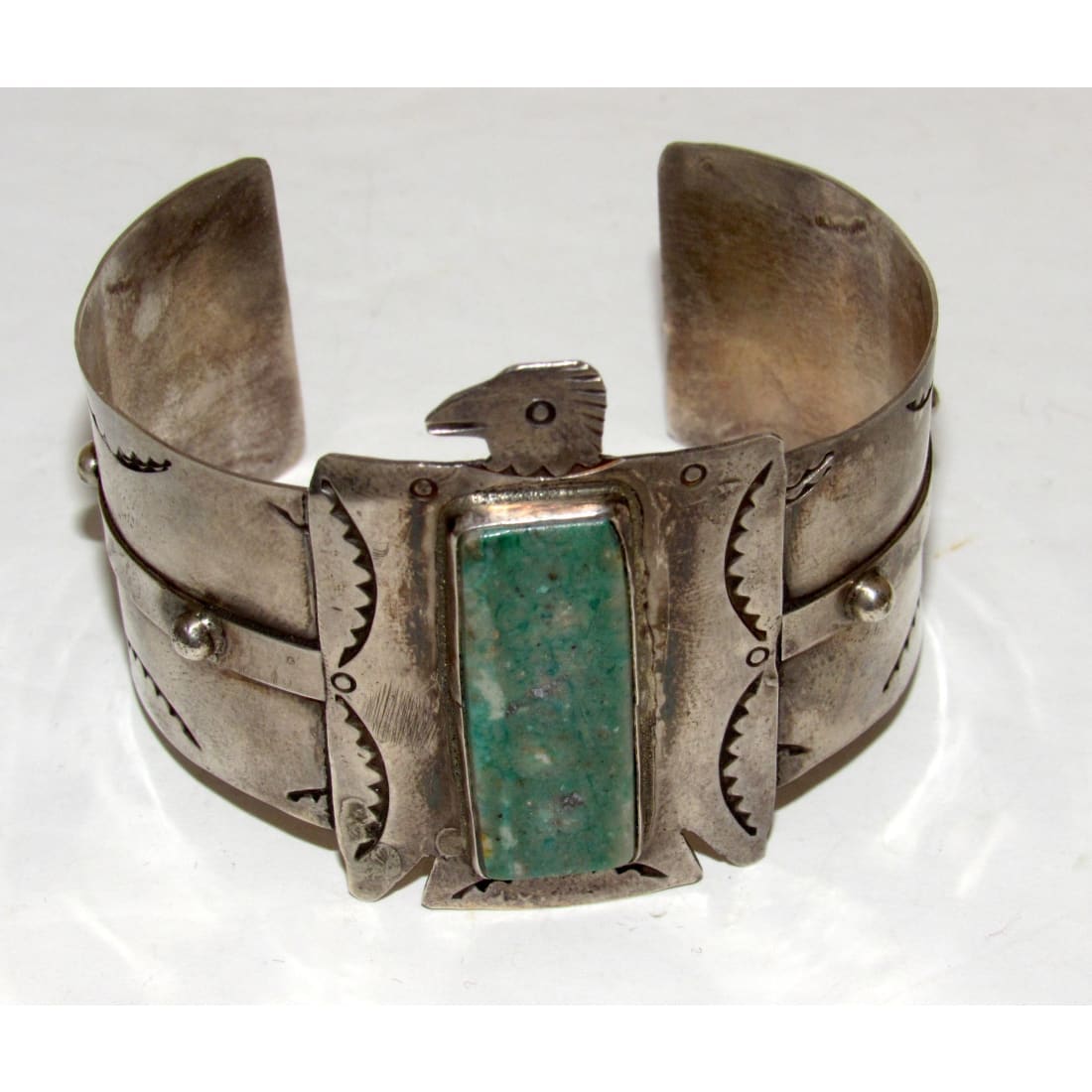 Native American Navajo Thunderbird cuff bracelet with turquoise stone and intricate silver detailing