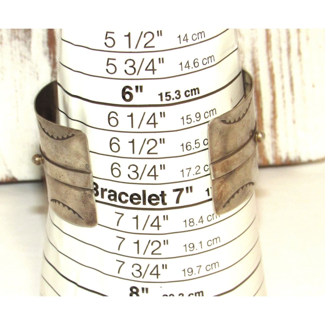 Native American Navajo Thunderbird cuff bracelet in silver displayed on size measurement cone