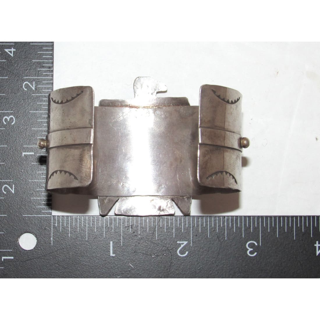 Native American Navajo Thunderbird cuff bracelet with engraved tribal designs and measuring rulers