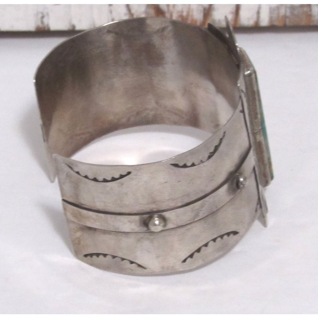 Native American Navajo Thunderbird cuff bracelet in silver with engraved designs and raised accents