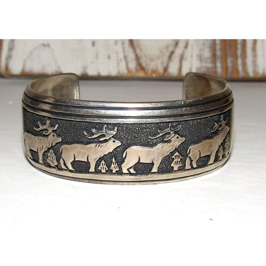 Native American Tommy Singer sterling silver bracelet featuring detailed elk and tree designs